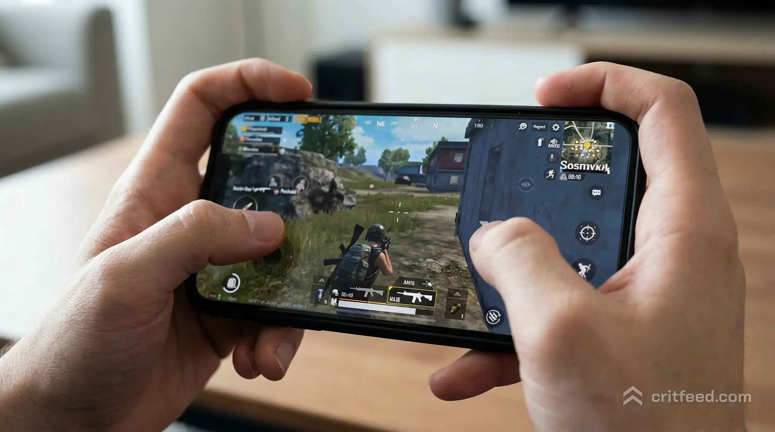 Close-up of two thumbs on a phone screen mid-match in PUBG Mobile, the hands angled in a claw grip, index fingers resting on