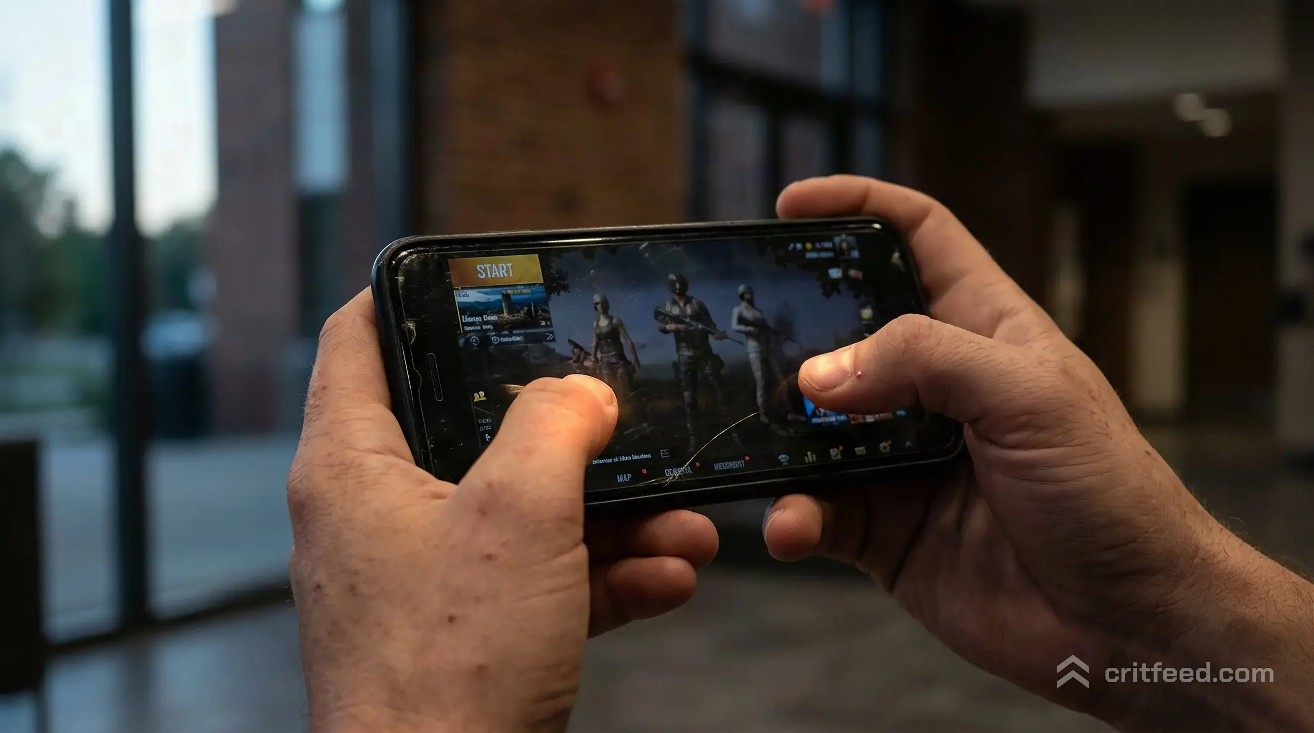 a worn phone screen held in both hands at dusk, the glow of a lobby selection menu reflecting faintly on the thumbs, no